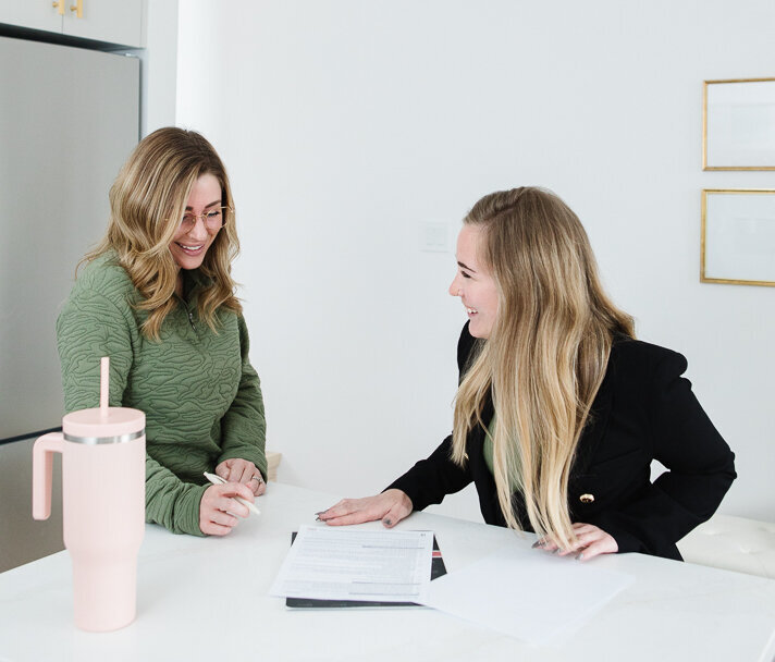 Realtor Tamara Rzan laughing with a client while explaining the sale process