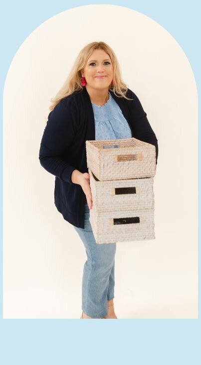 Nicole Naugle owner of Lakeshore Interior Design  holding  organizing bins