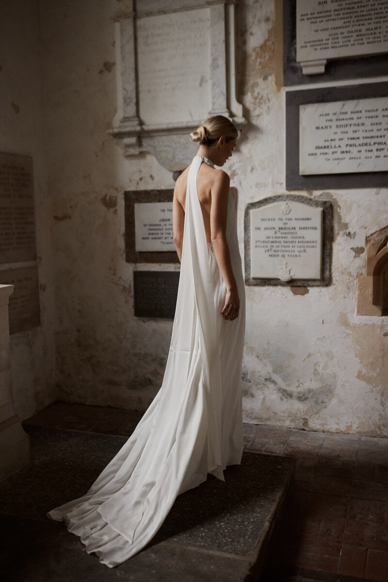 Bride wearing backless long wedding dress in silk in church