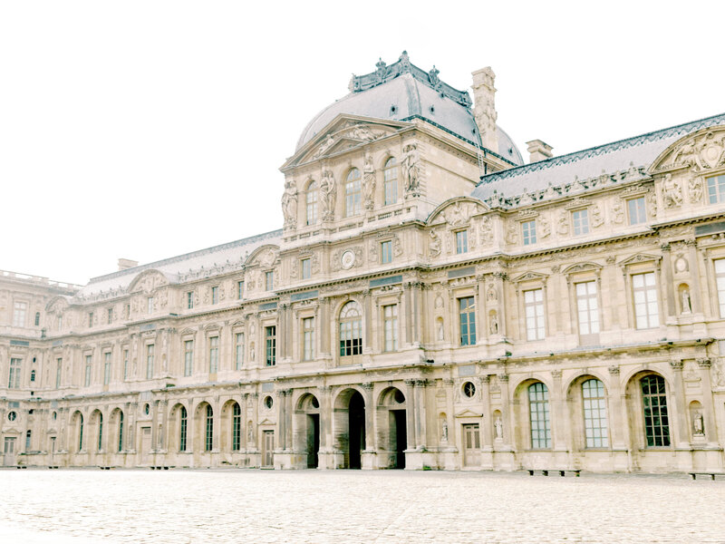photograph of the louvre museum in the morning