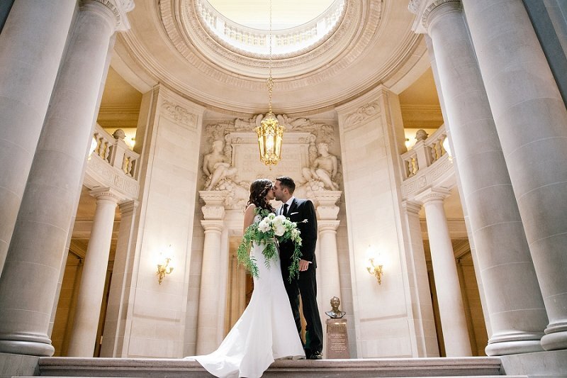 A couple kissing in the ratanda in San francisco City Hall. 