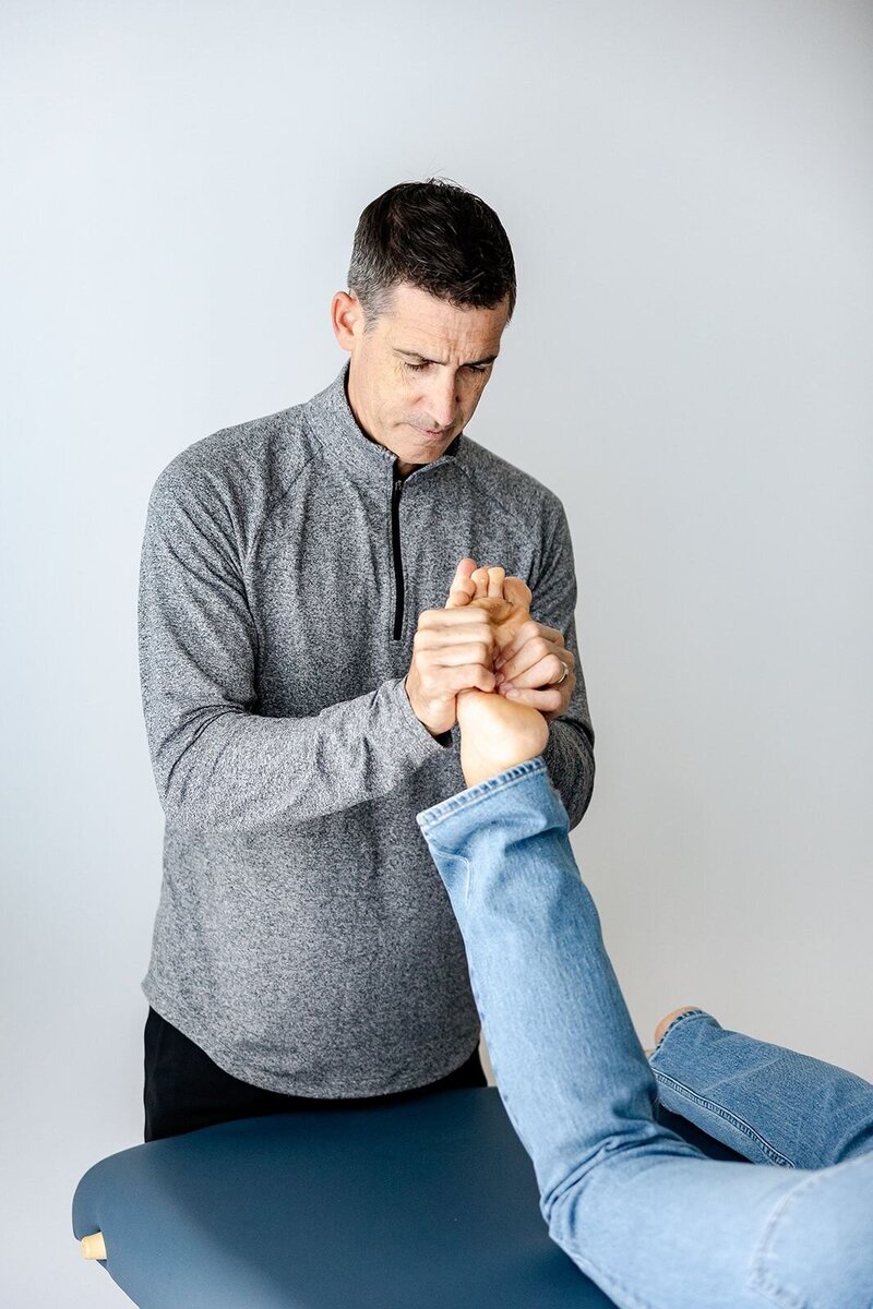 Chris Warden Owner of Embody, Doctor of Physical Therapy,  & PhysioCoach working with a patient