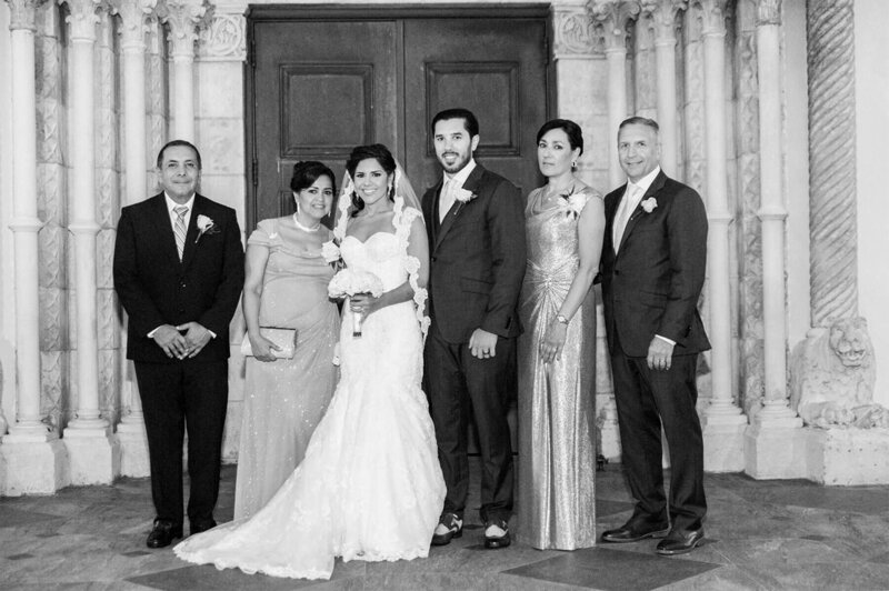 Bride and groom pose with family for formal wedding portraits at St. Patrick Catholic Church in Miami Beach.
