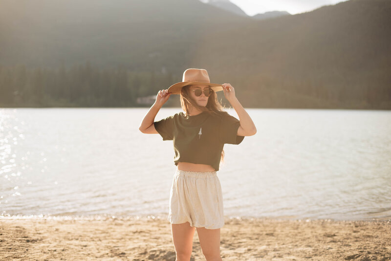 Woman on beach by the lake modeling for clothing company