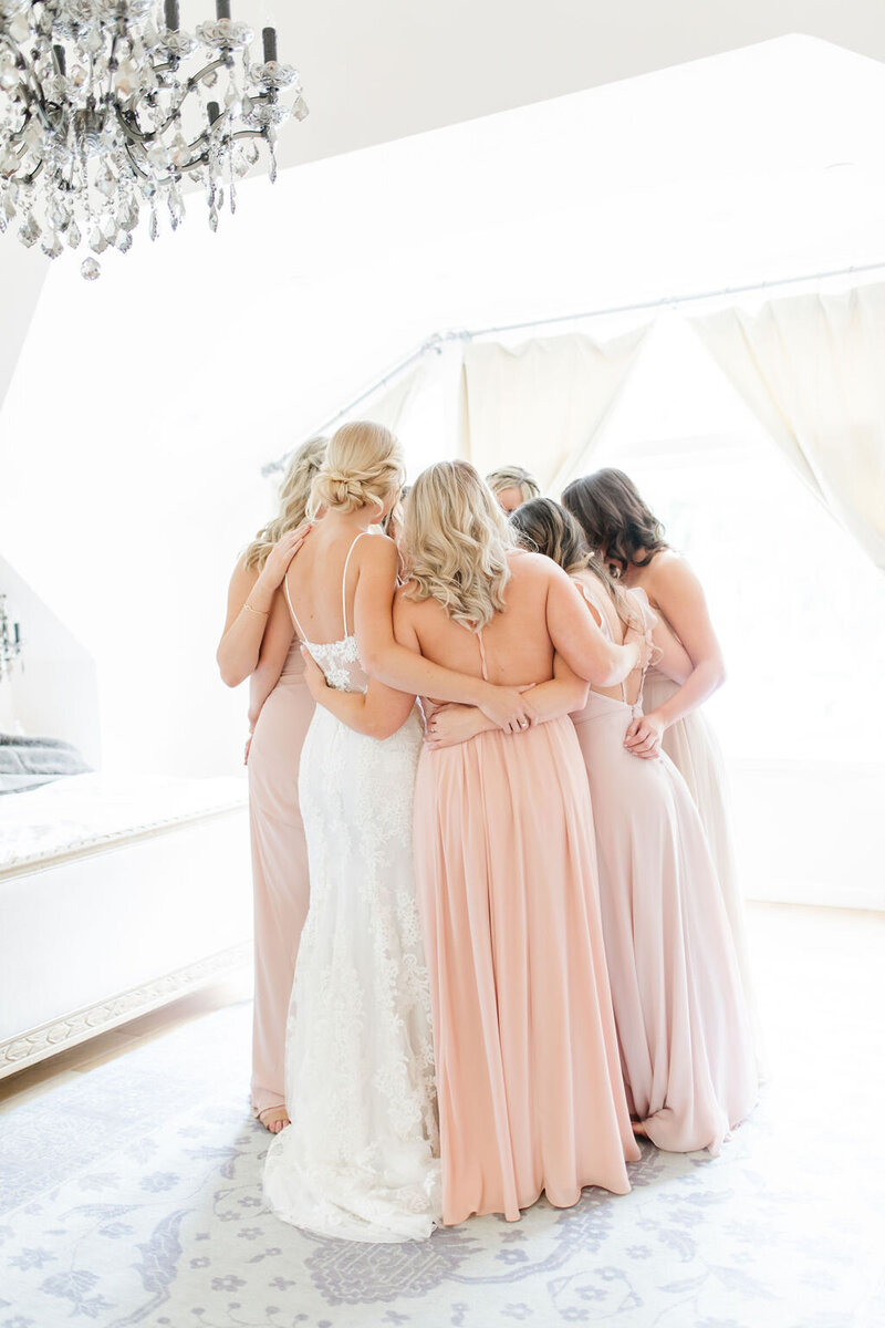 Bridesmaids on wedding day embracing each other before ceremony