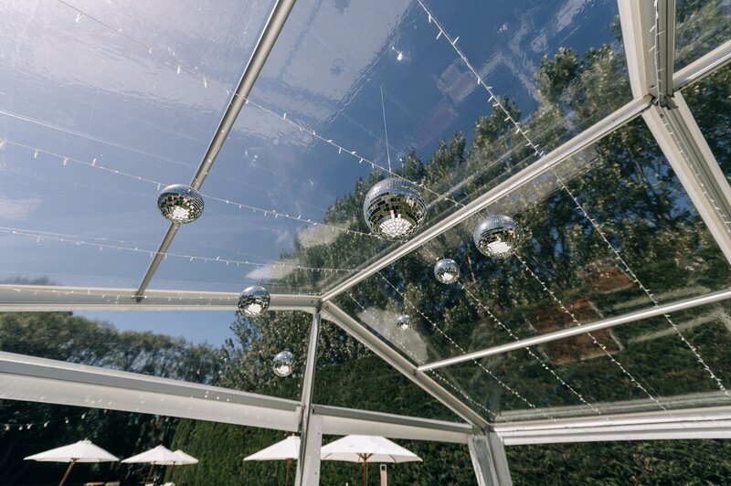 disco balls hanging in clear marquee by loula hire in christchurch nz on sunny day wedding reception decor idea