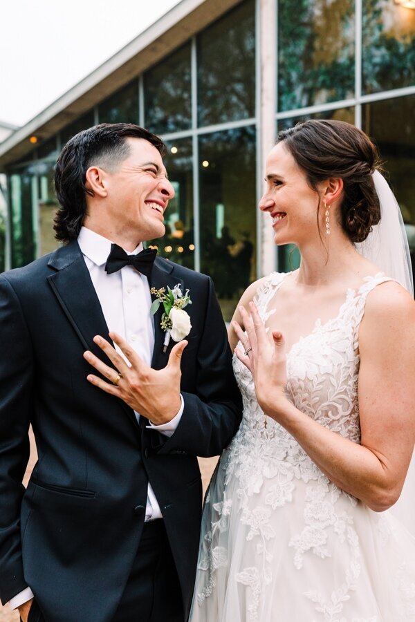 Bride and groom happily showing their wedding rings after the ceremony, celebrating a fun and relaxed wedding day in Austin, Texas.