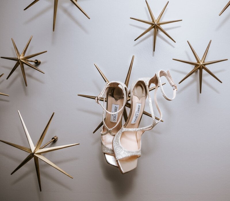 Sparkling Jimmy Choo bridal heels photographed against a modern starburst accent wall at The Grand Galvez in Galveston, TX 