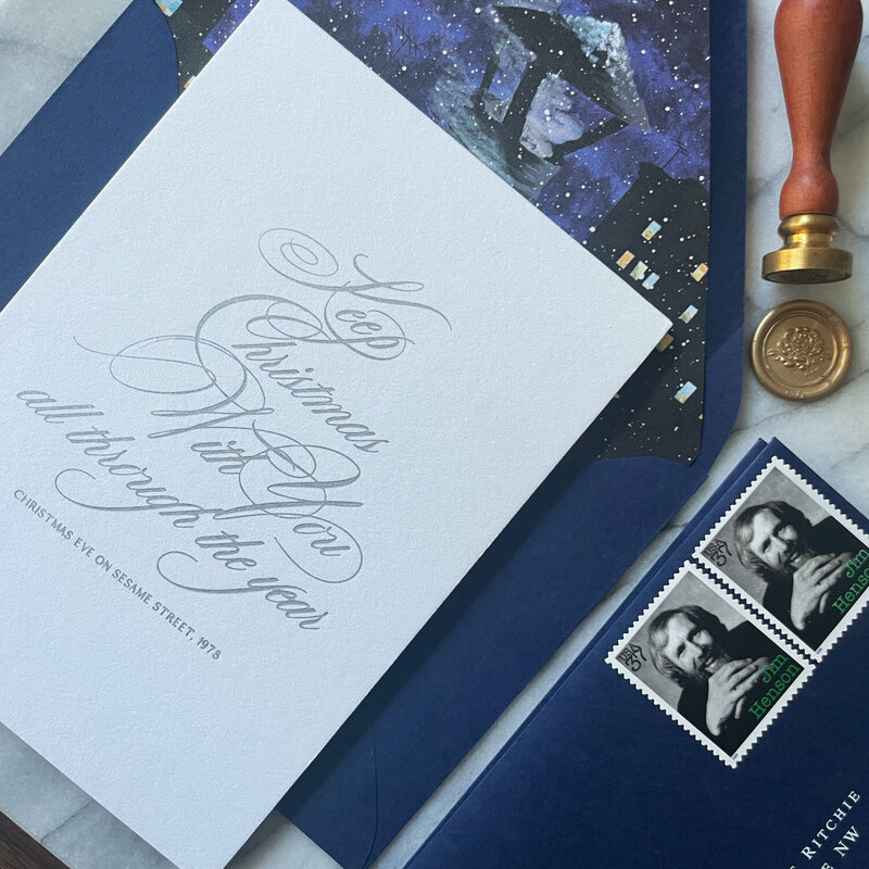 Festive holiday stationery with blue envelopes and wax seal