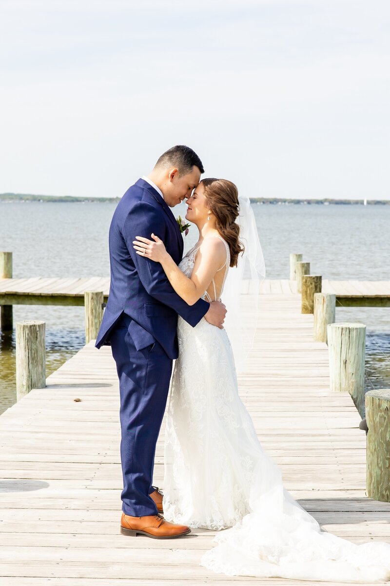 Bride and groom smiling at each other as they gaze into each others eyes