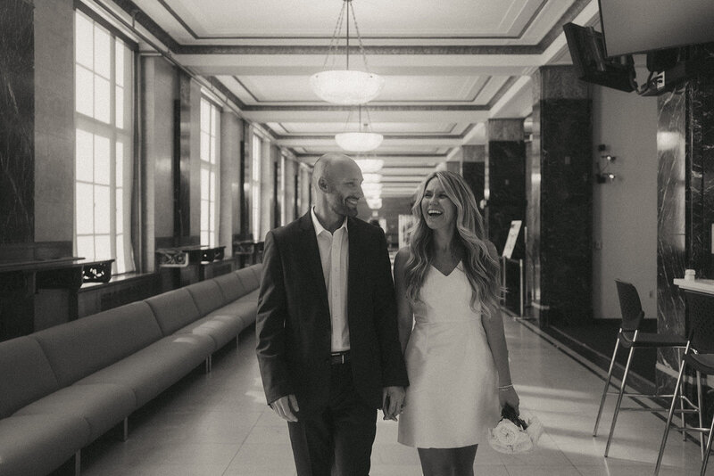 bride and groom walking at city hall before eloping shot by Elsie Goodman Photography | NYC Elopement Packages