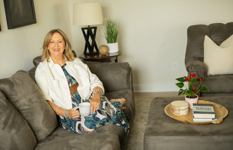Woman on couch with cup of coffee