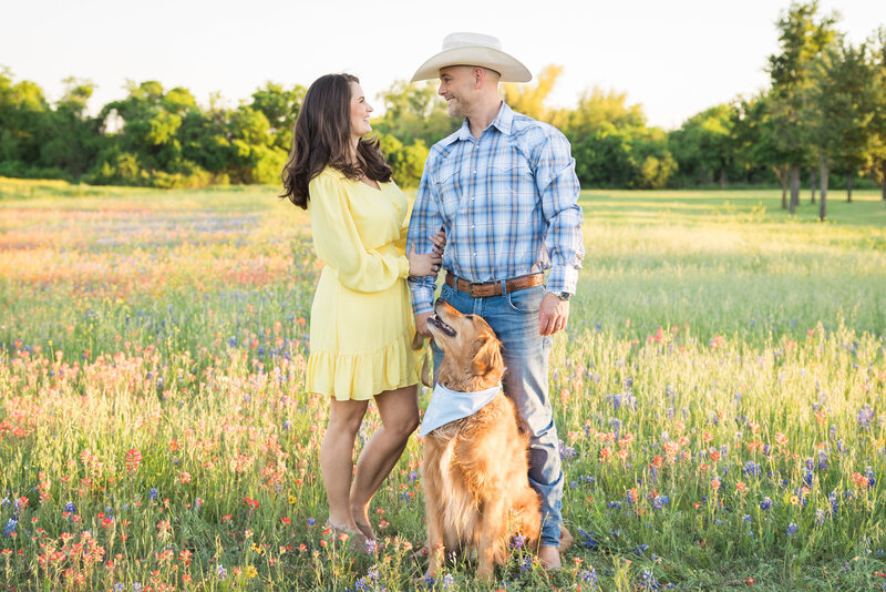 couple looking at each other with dog