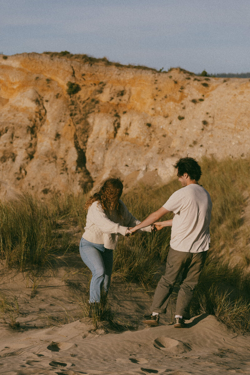 A couple spinning in a circle together while holding hands 