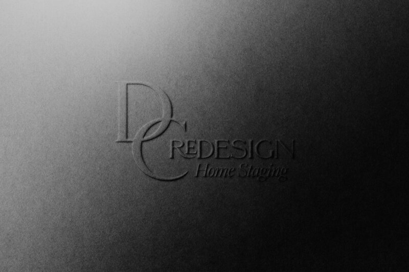 Luxury branding service for client, DC Redesign Home Staging. A typographic logo in embossed black with the words "DC Redesign in a black font. The words: "Home Staging" appear under also in a black font.