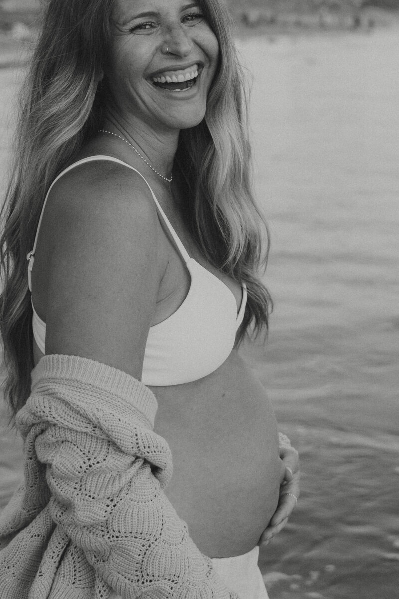 a woman's pregnant stomach in black and white
