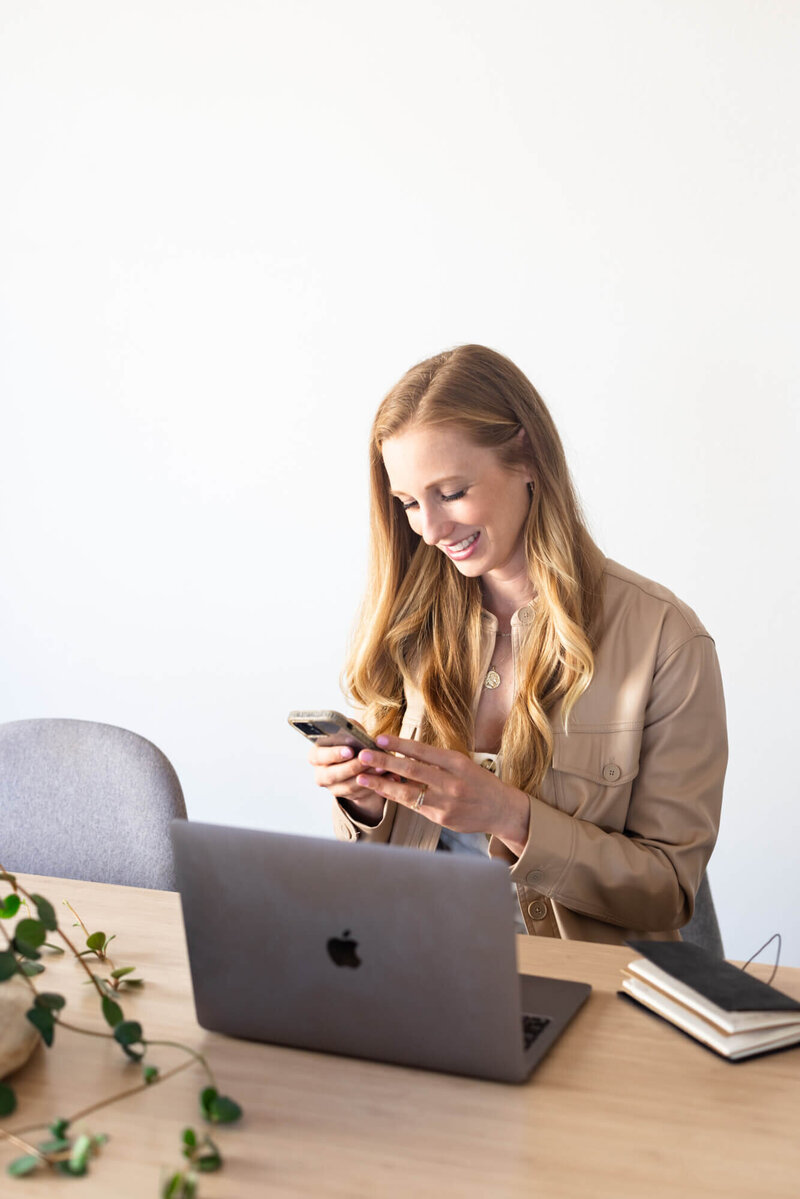 Mary Pernicano, San Diego realtor, working from her laptop and phone during a client consultation — Mary Pernicano Real Estate.