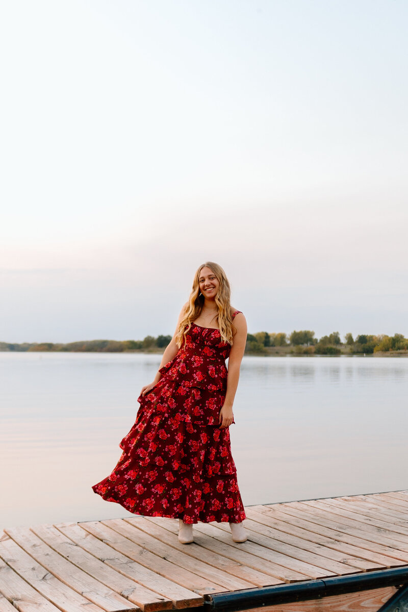 girl poses for senior photos in dress