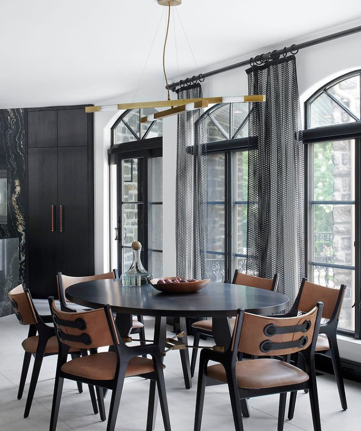A dining room with black custom window treatments