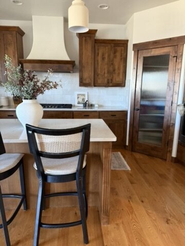Bright kitchen with natural wood accents and white countertops designed by KSC Interiors.