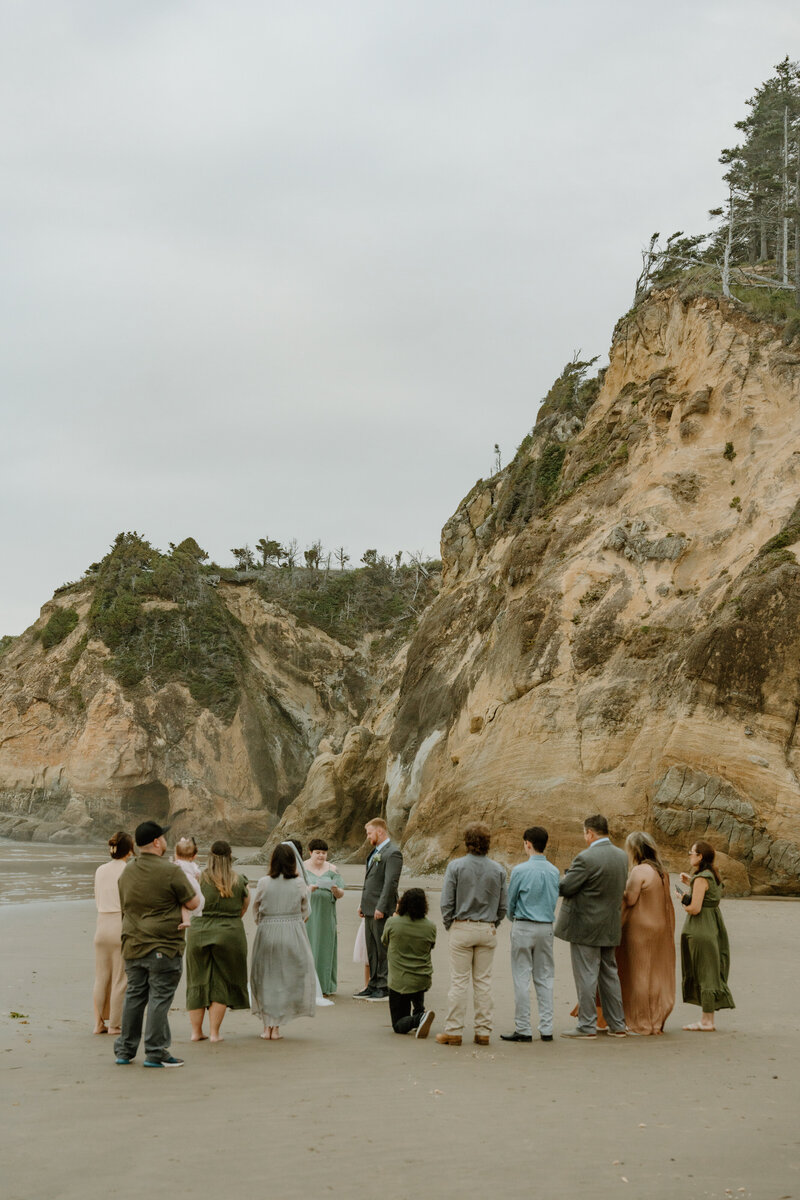 Family stands around a couple during their Cannon Beach elopement. 
