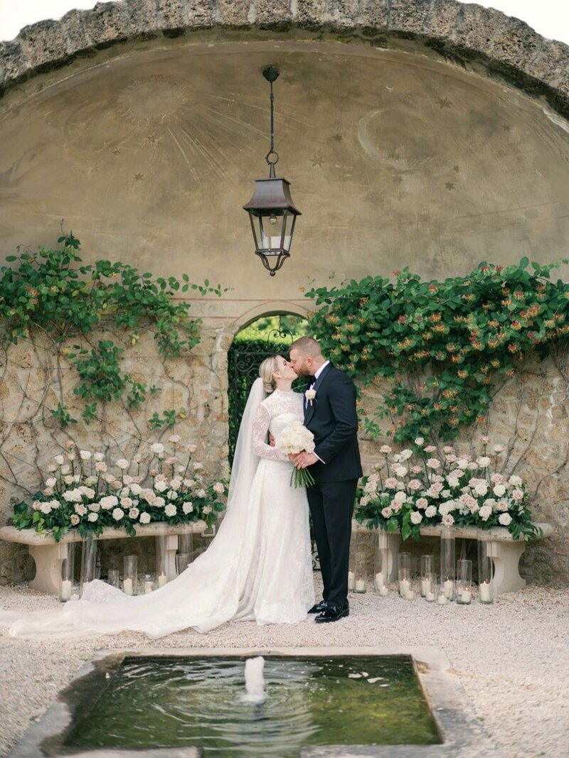 Couple embracing and kissing at Wedding ceremony at Borgo Santo Pietro in Tuscany