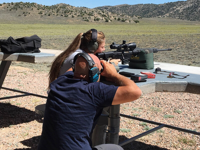 Girl learning to shoot a gun at Firearm Training