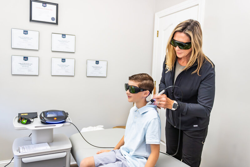 Dr. Tori performing red light therapy.