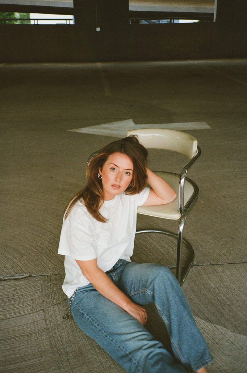 woman next to a chair