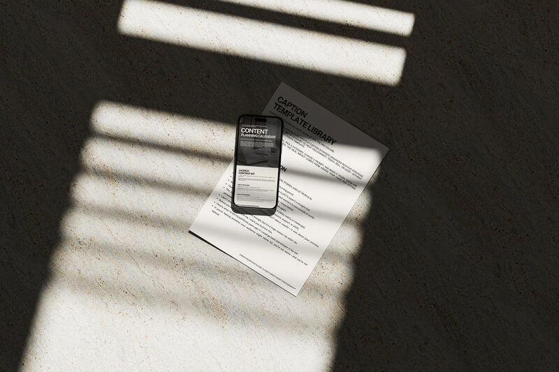 Overhead view of printed photography contract templates and mobile preview of the Legal Starter Kit for photographers