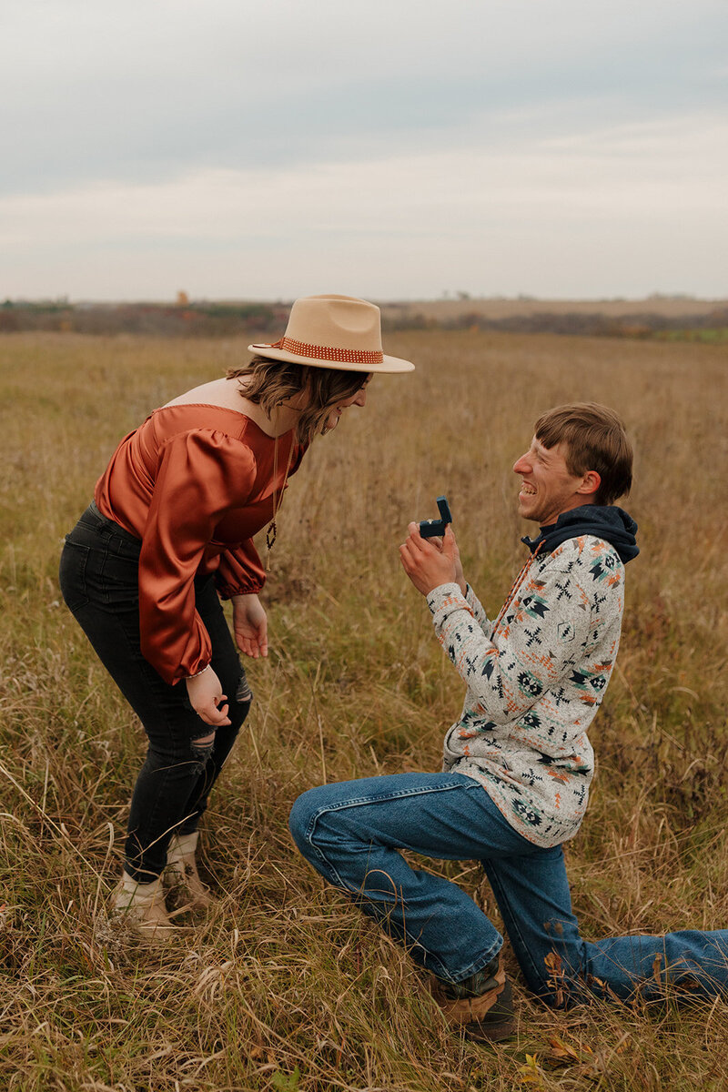 mount horeb wisconsin wedding proposal. groom is on one knee while bride is happily surprised