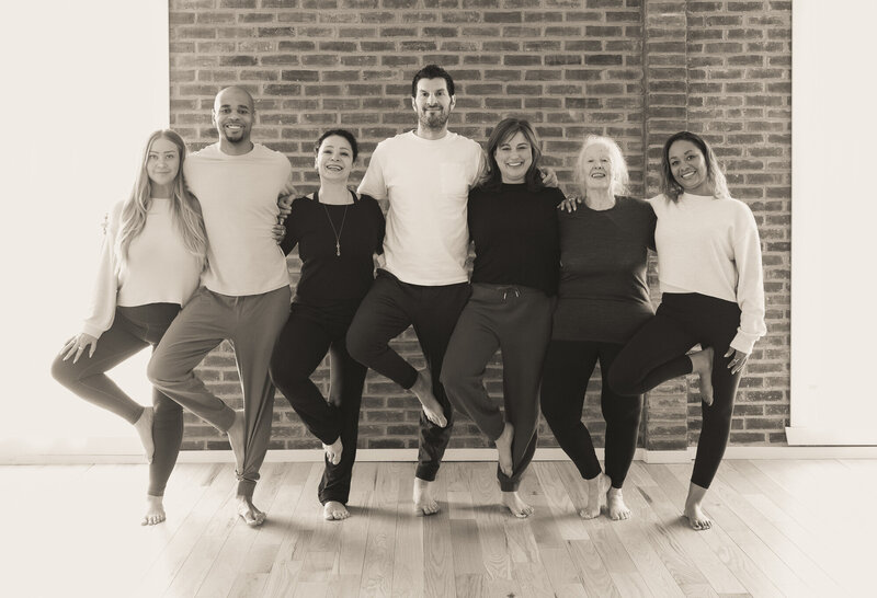 Bunch of yogis doing tree pose in group