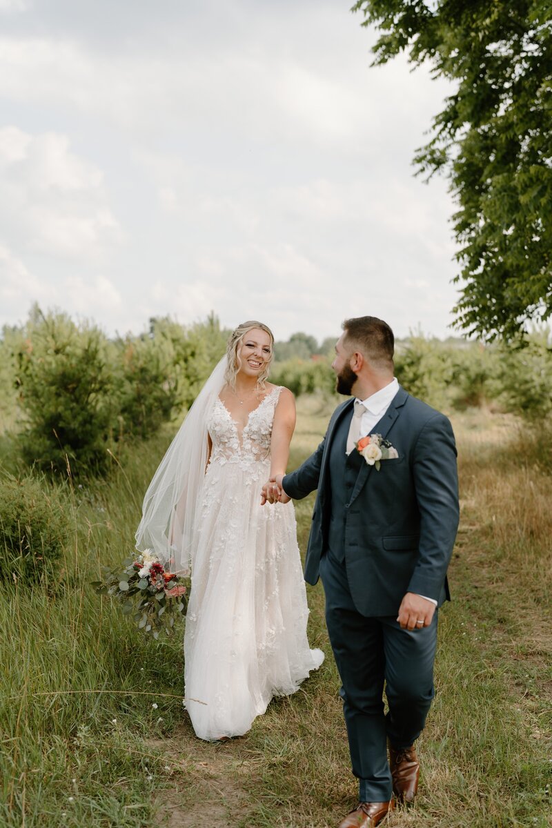 bride and groom walking towards camera
