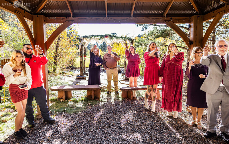 Toasts Under the Awning at Romantic Riversong Inn Estes Park Elopement Wedding Venue in CO