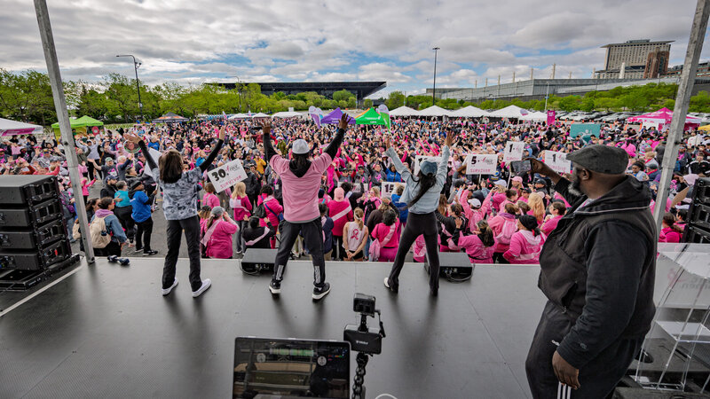 DJ Marz performing in the crowd with matching pink outfit