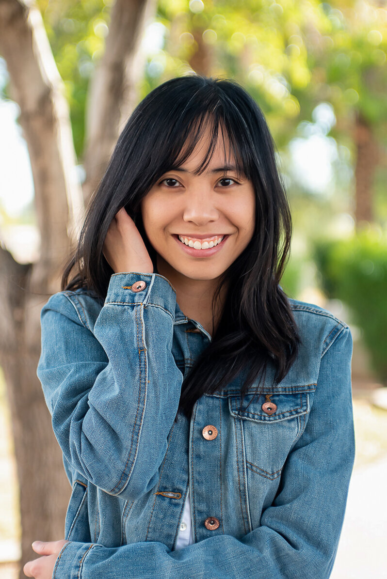 Newfound Sense founder, Laci Le, smiles wearing a denim jacket in Chandler Park