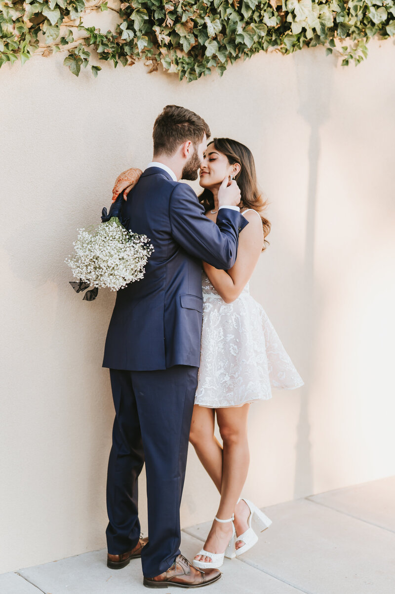 Bride and Groom kissing with cathedral in background