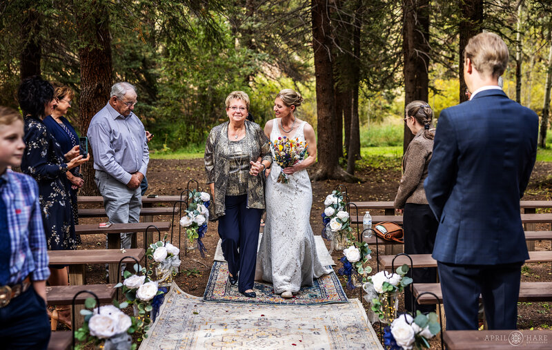 Bride Walks Down Aisle with her Mom at Beaver Ranch Wedding Venue in Colorado