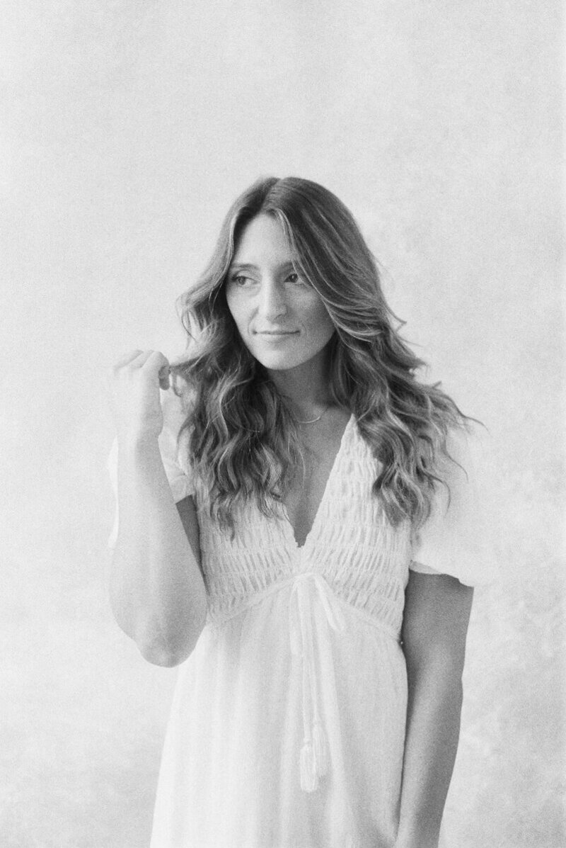 A headshot of Kayla Victor, owner of Kayla Mari Photography