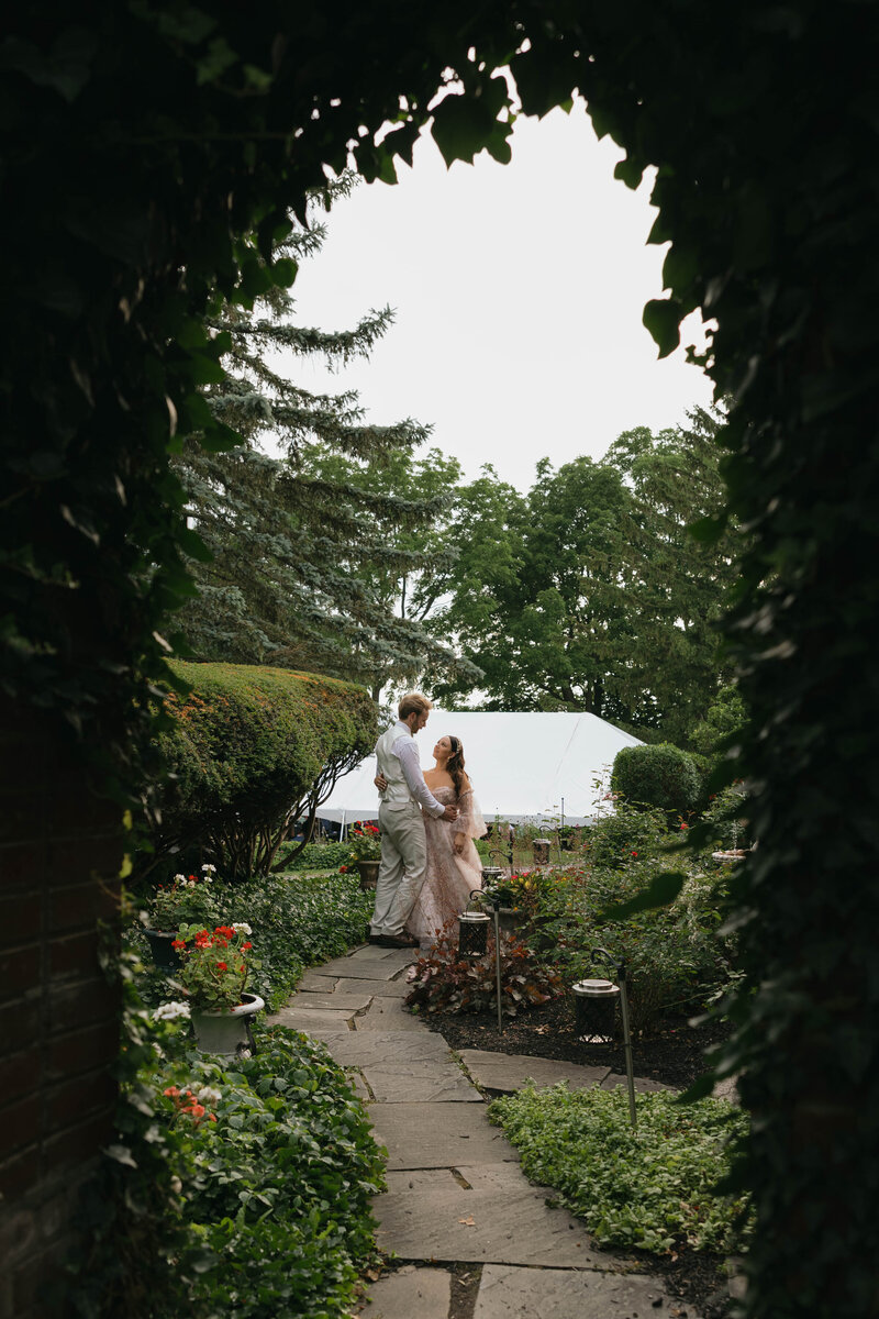 Bride and groom in lush greenery by Temecula wedding photographer