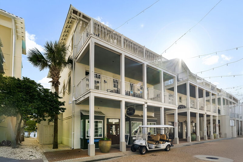 Row of Carillon Beach vacation rentals illuminated with festive string lights in Panama City Beach.