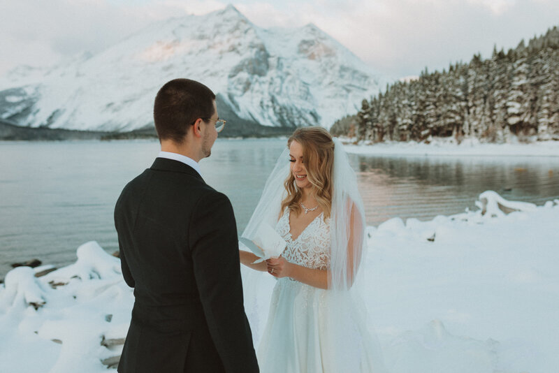 vow reading  snowy winter elopement in kananaskis by liv hettinga photography a calgary wedding photographer