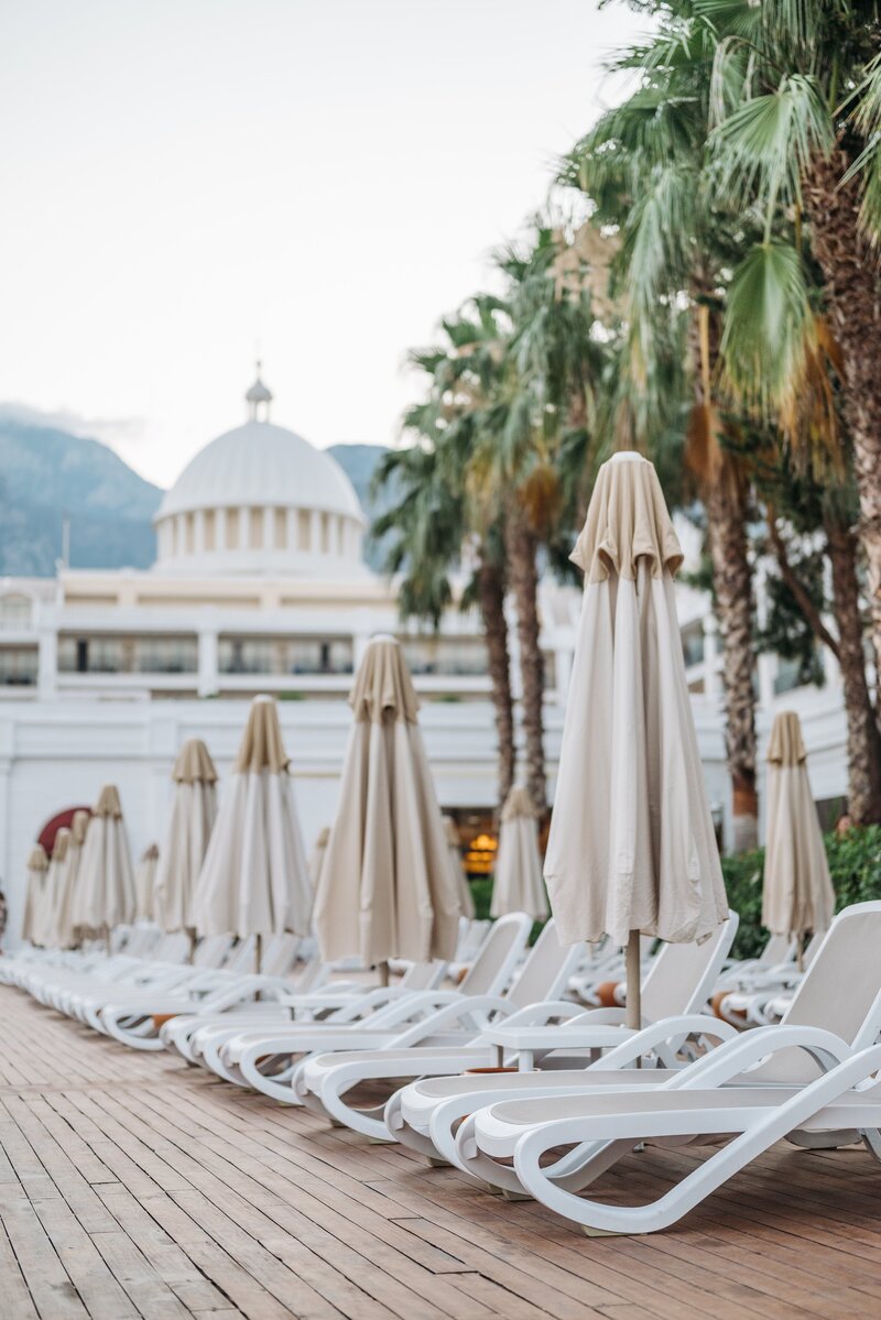 orange sunbeds by the water