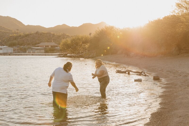 couple splashes in lake