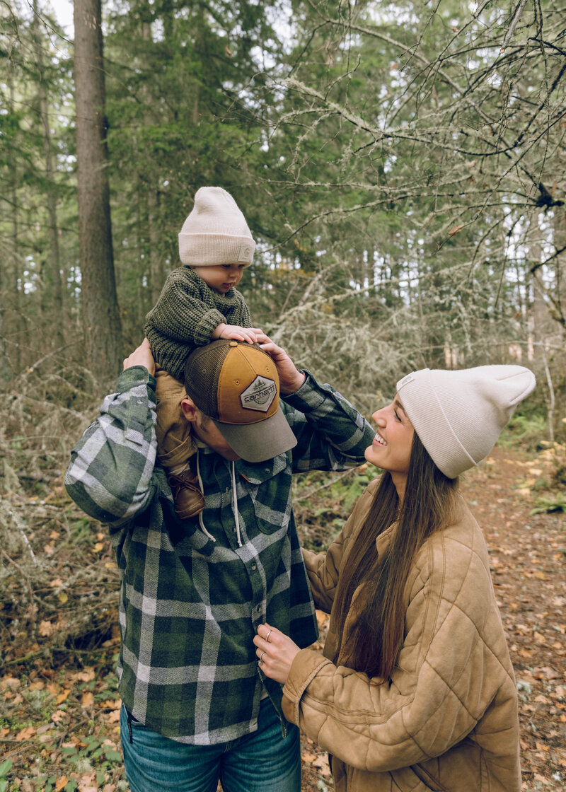 Family of 3 posing in the washington forest for a family photoshoot