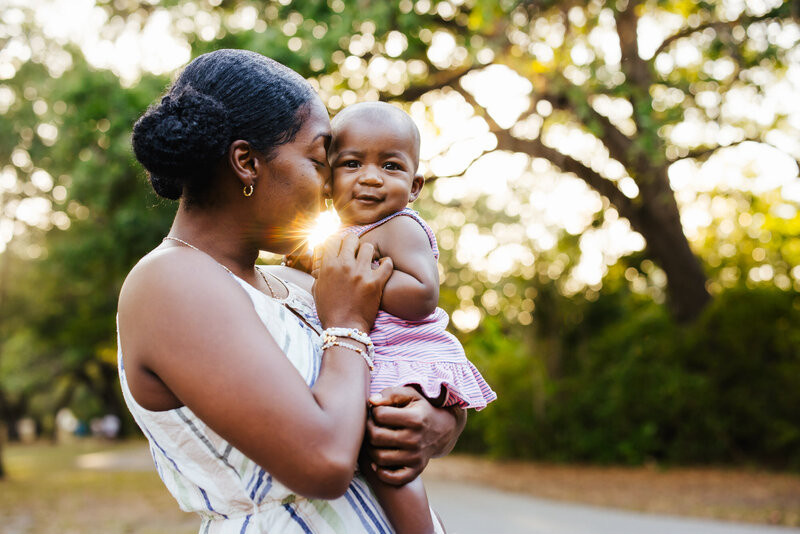 Mom cuddling her baby during golden hour photo session in Albany, New York
