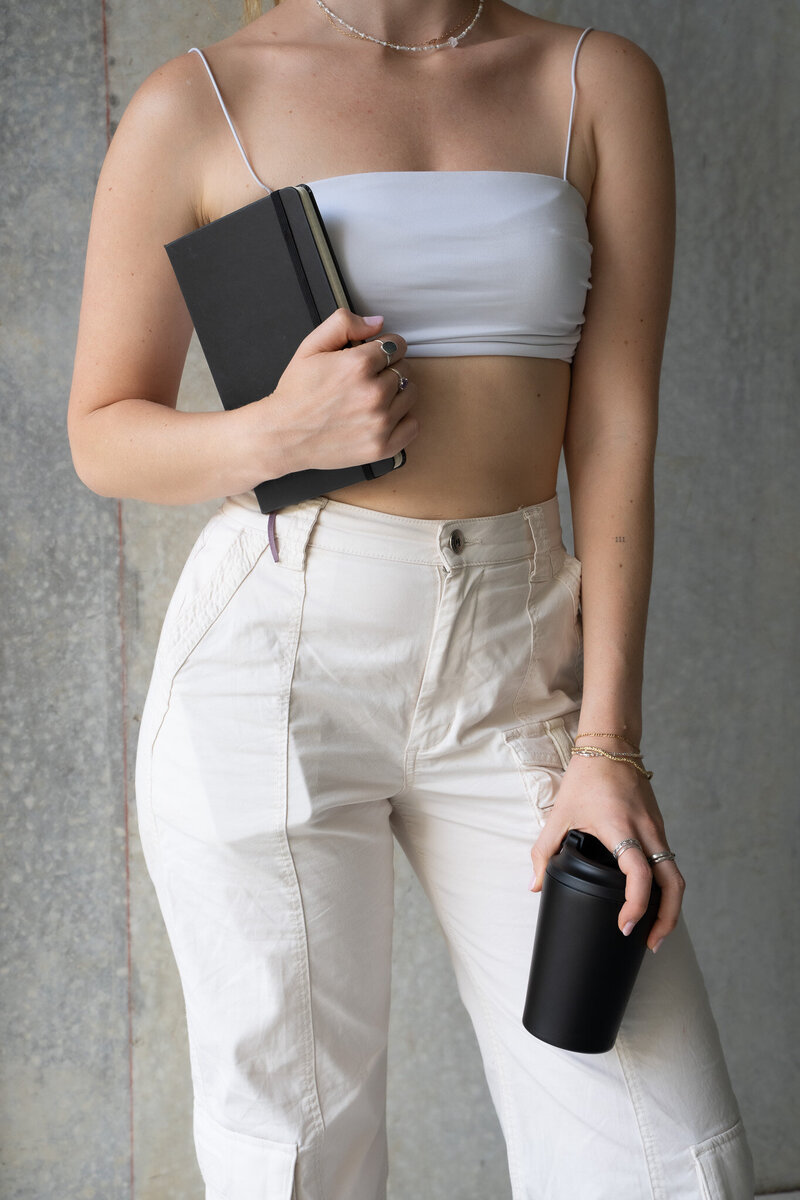 Minimalist chic entrepreneur with planner and coffee cup