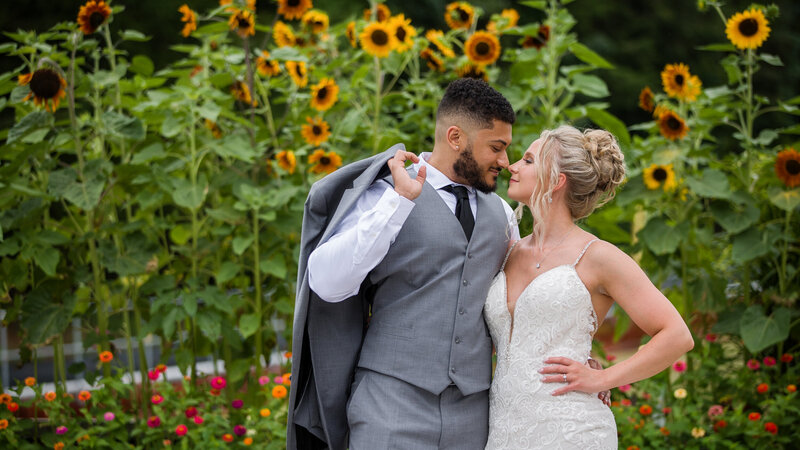 Couple sharing a quiet moment surrounded by vibrant sunflowers at Blue Mountain Resort in the Poconos.