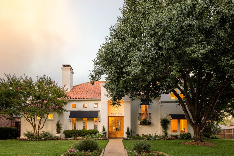 A beautiful two-story Mediterranean-style home with a warm and inviting presence. The exterior features a crisp, light-colored stucco façade paired with a classic terracotta tile roof.