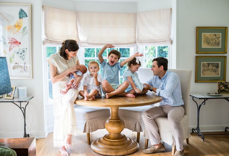 fort worth family being silly together on dining table for in home photo session